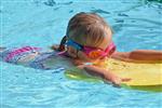 Little Girl Swimming With Her Body Board